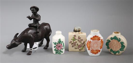 Four Chinese snuff bottles and a small bronze of a man riding an ox